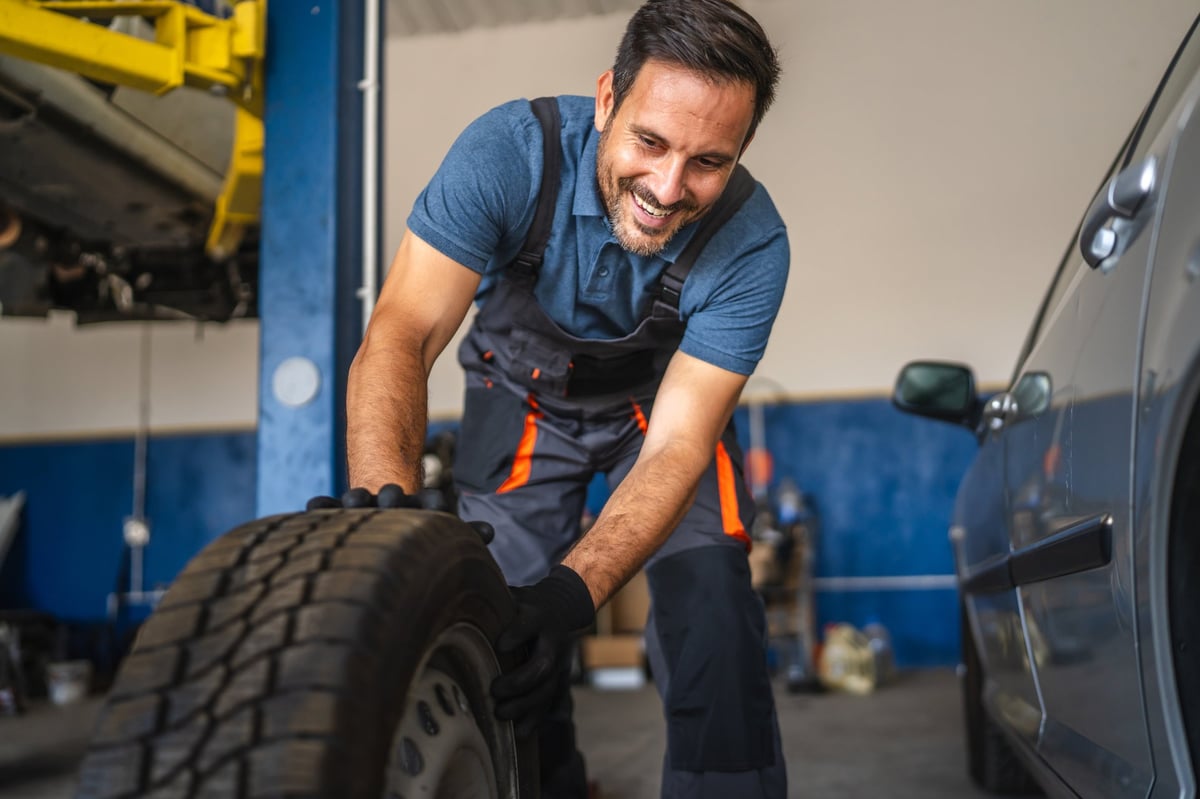 Professional mechanic servicing a tire
